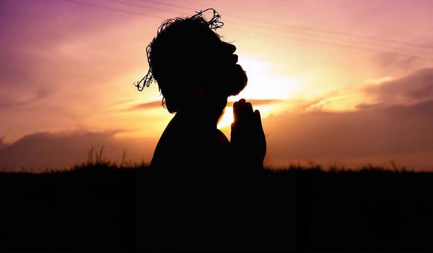 A person with their hands in prayer